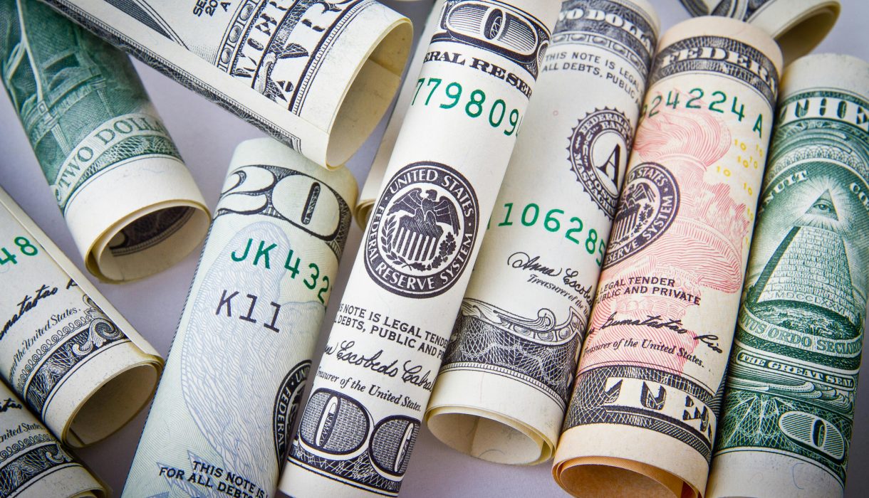 Close-up of rolled US dollar bills symbolizing wealth, financial success, and currency.