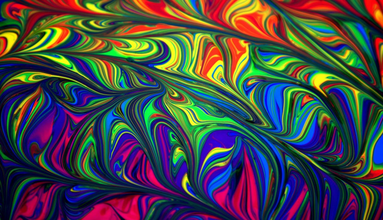 Colorful abstract swirl pattern with vibrant rainbow hues creating a dynamic and artistic background.