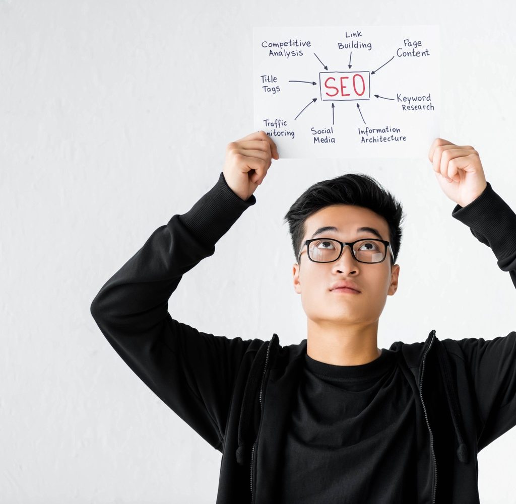 asian seo manager holding and looking at paper wit shmz5sy.jpg